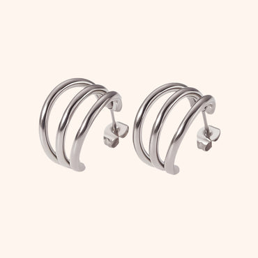 Pair of silver hoop earrings on a white background