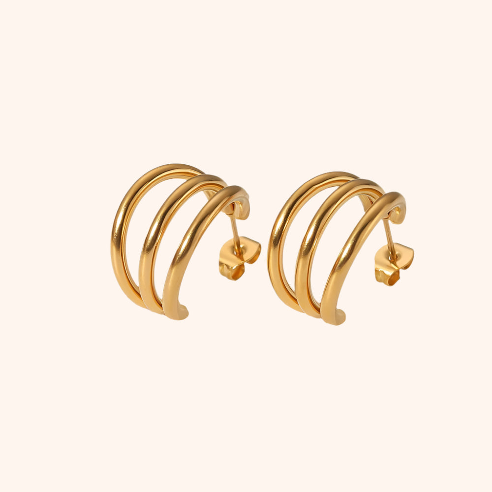 Pair of gold hoop earrings on a white background