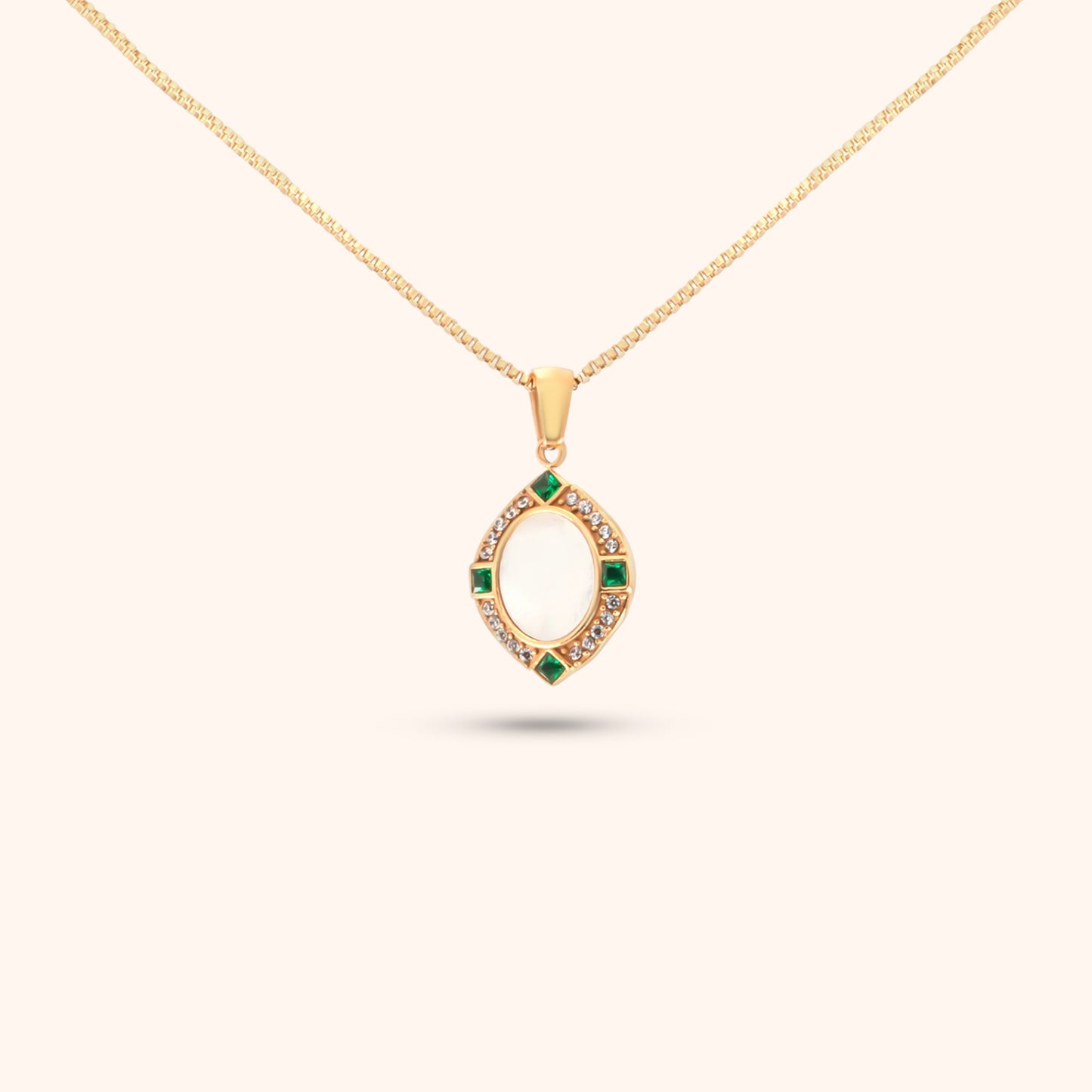 Close-up of the Navigator Pendant, a gold necklace featuring a unique geometric pendant with small colored stones.