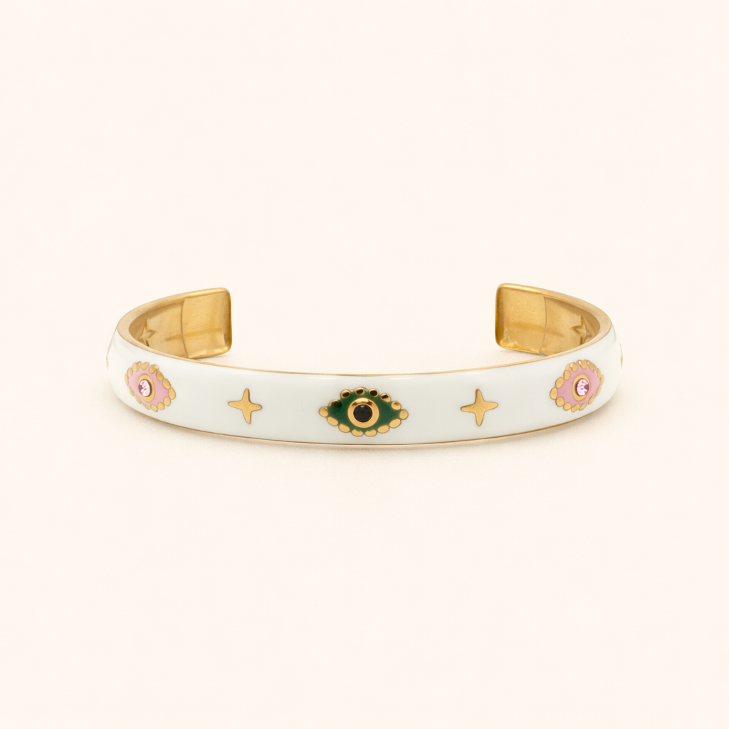 Gold and white bracelet with decorative elements on a white background