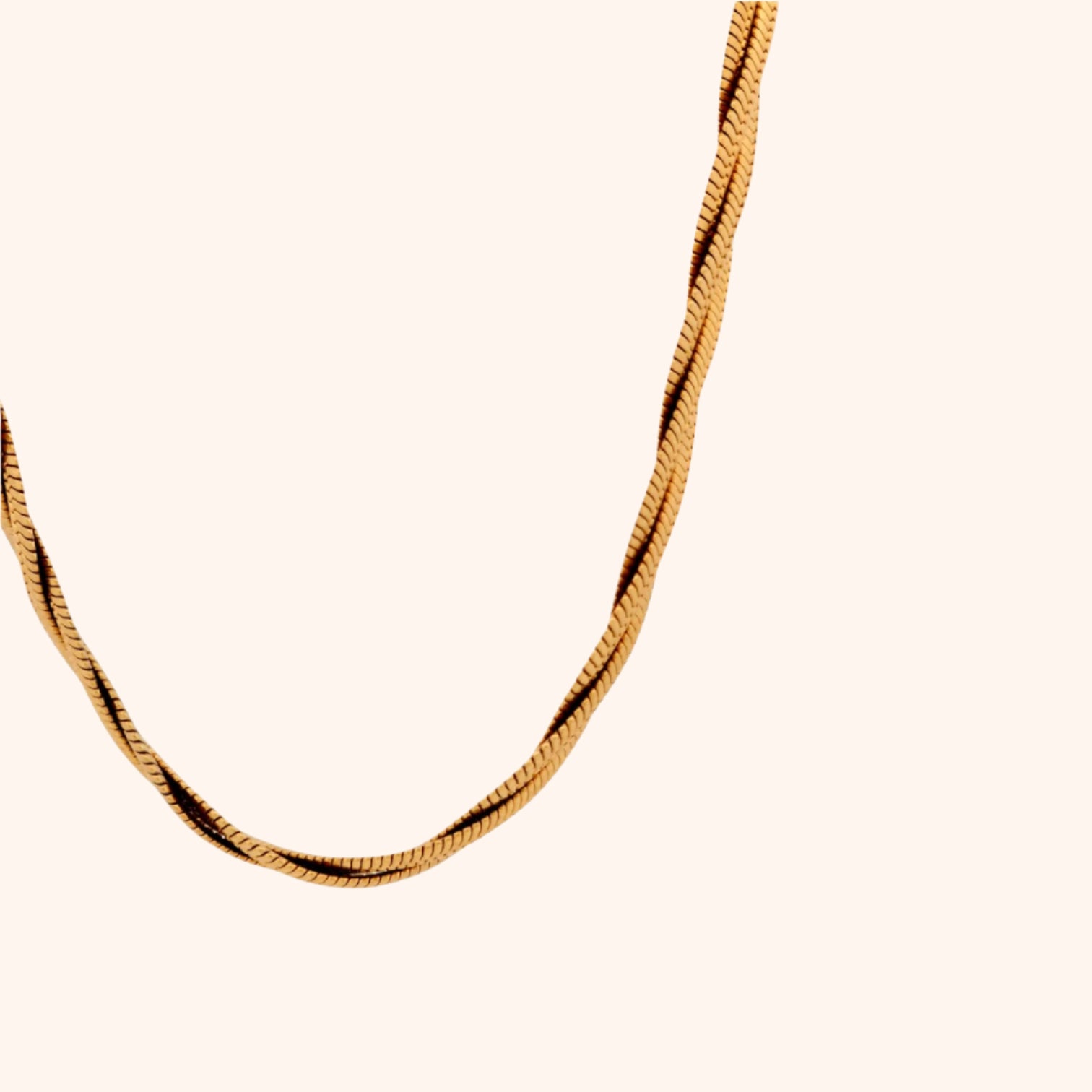 Close-up of a gold twisted herringbone chain necklace, showcasing its intricate design and reflective surface.